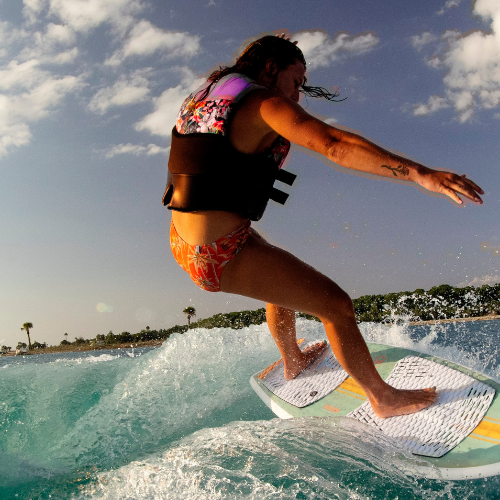 Woman riding a Ronix Wakesurf Board