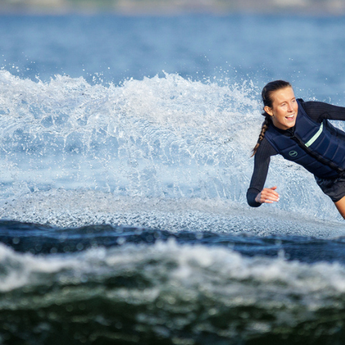 Woman wakeboarding and holding onto a wakeboard rope