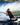 Female rider carving on the Ronix Quarter 'til Midnight board with Halo open-toe boots, showing a high-performance women's boat setup.