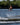Young grom wakeboarder confidently executing a clean wake-to-wake jump and grab on the complete 2026 Ronix Kid's District 129cm wakeboard package.