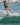 Female wakeboarder confidently cutting into the wake on a heelside edge using the 2026 Ronix Krush wakeboard setup.
