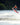 Intermediate youth rider performing a massive wake-to-wake tail grab on the 2026 Ronix District 129cm.