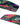 Detailed view of the 2026 Ronix Rise bottom featuring vibrant pink fins and advanced channels.