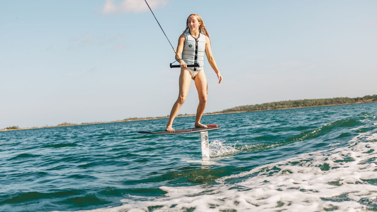 Woman learning how to wakefoil on the 2026 Ronix Beginner Shift Mast Wakefoil | Wakesports.com