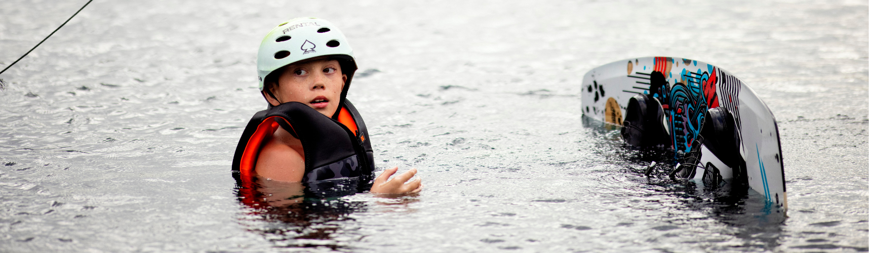 Kid floating in the water while wearing a CGA life vest