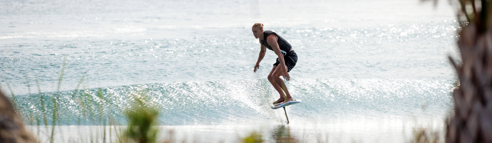 Man riding a Ronix Wake foil board in the ocean