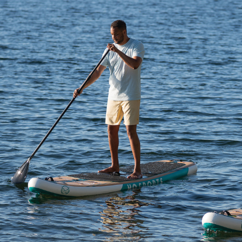 Two men paddling inflatable stand up paddle boards