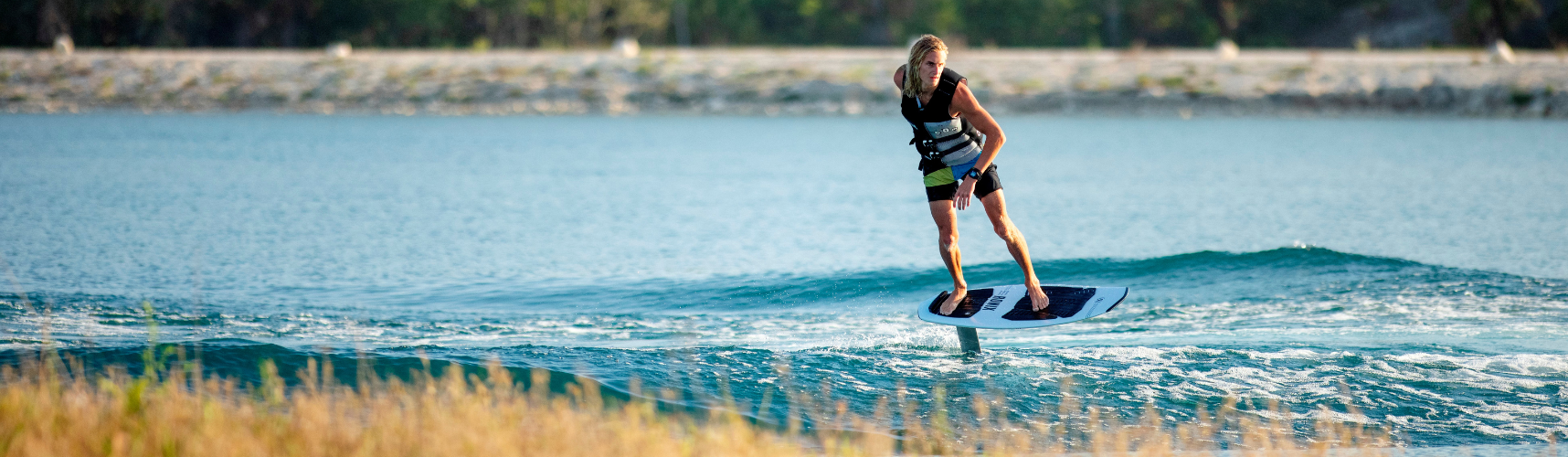 Woman riding a Ronix Koal Surface 727 Wakefoil in a lake
