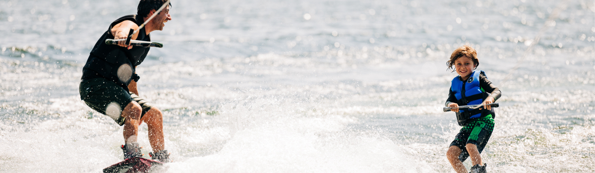 Dad and son wakeboarding together