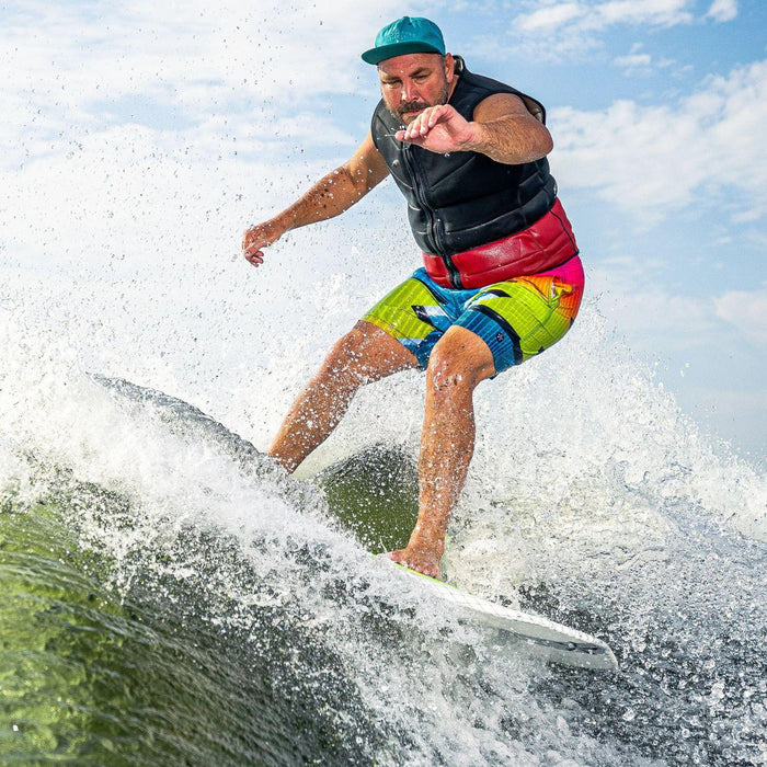 Big rider performing an aggressive slash on the crest of the wave with the 2025 Phase 5 Doctor.