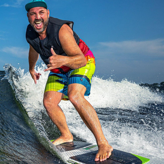 A larger wakesurfer throwing a "hang loose" hand signal while cruising effortlessly in the sweet spot on the Phase 5 Doctor.