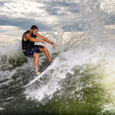 Pro rider John Akerman throwing a huge spray with an aggressive slash on his signature Phase 5 Ahi.