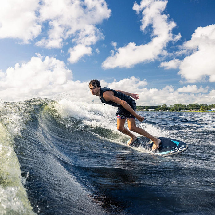 Rider executing a deep bottom turn and cutting back into the wake on a Phase 5 Hypsta.