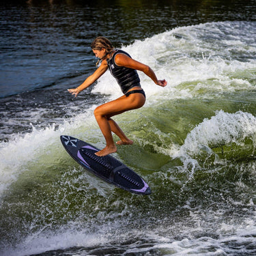 Pro wakesurfer Ashley Inloes performing a technical 360 shuv-it on her pro model Phase 5 Mindset.