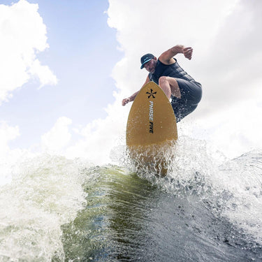 Wakesurfer launching a clean ollie air off the wake on the 2026 Phase 5 Model X LTD.