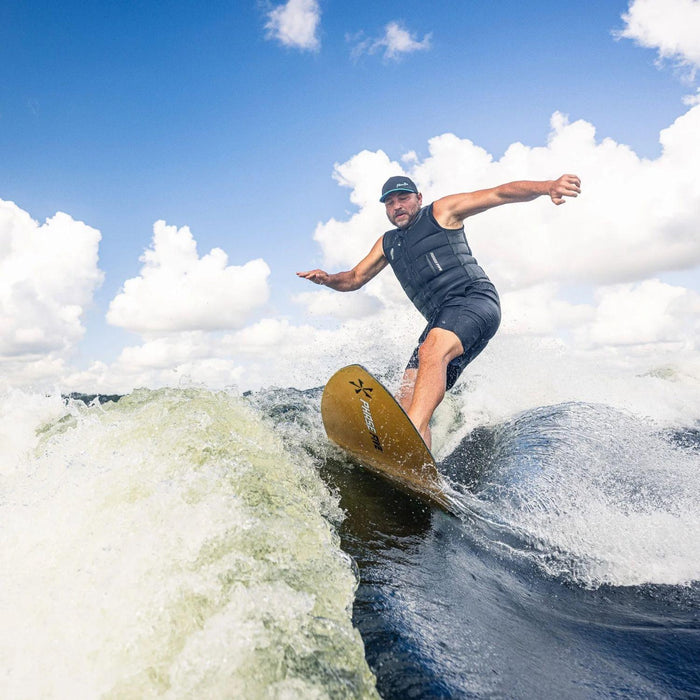 Rider performing a powerful carve on the lip of the wake with the Phase 5 Model X LTD.