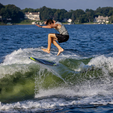 Pro wakesurfer executing a massive air 360 shuv-it on the responsive Phase 5 Party Crasher.