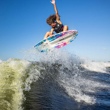 Pro rider Bailey Rush catching massive air with a clean ollie on her pro model wakesurfer, the 2026 Phase 5 Rush.