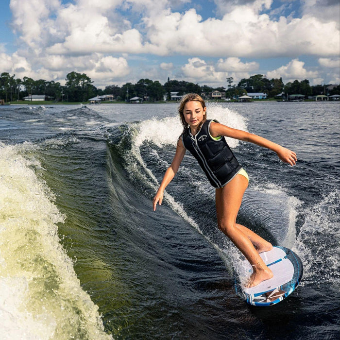 Youth rider performing a controlled bottom turn carve on the 2026 Phase 5 Scamp.