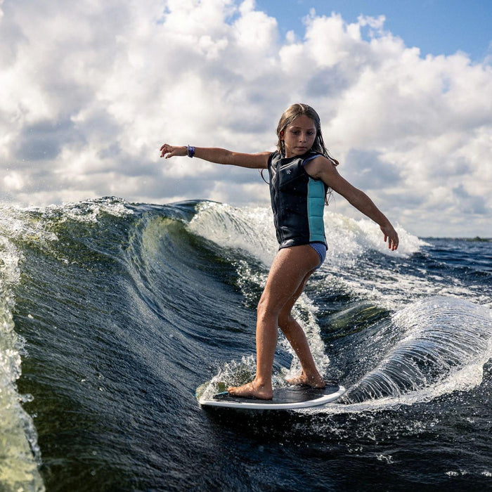 Youth rider performing a powerful carve on the wave with the 2026 Phase 5 Shrimp.