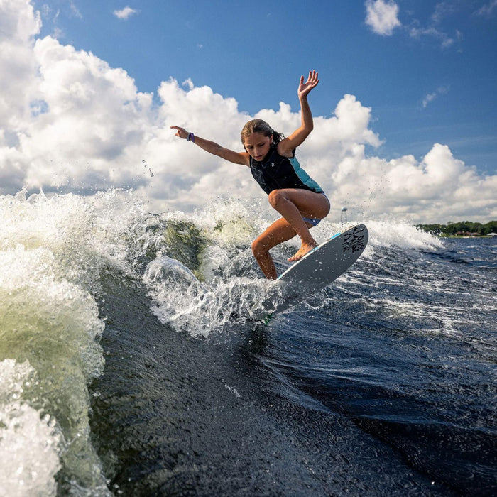 Young grom catching air with a clean ollie off the wake on the 2026 Phase 5 Shrimp wakesurfer.
