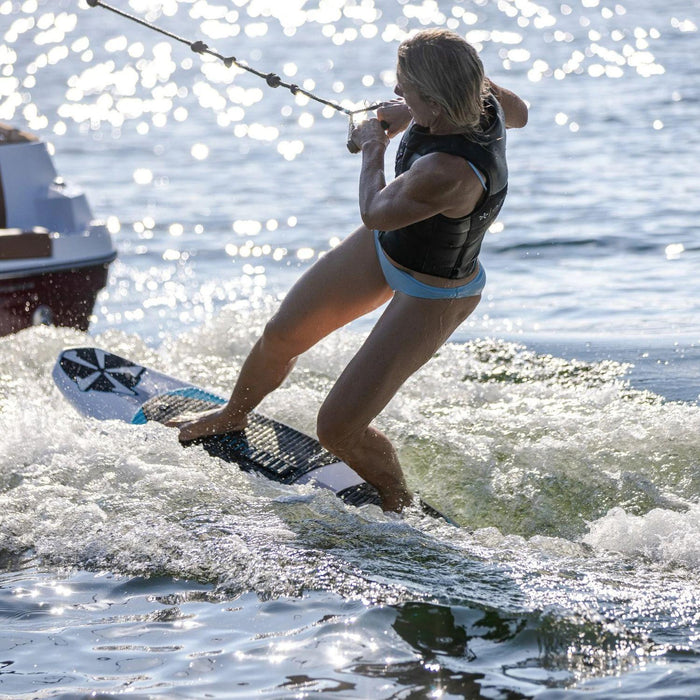 Stacia Bank getting up on the Phase 5 Swell, demonstrating how easy it is to start on this high-volume surf board.