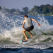 Male wakesurfer throwing a huge spray with a powerful slash on the 2026 Phase 5 Swell.