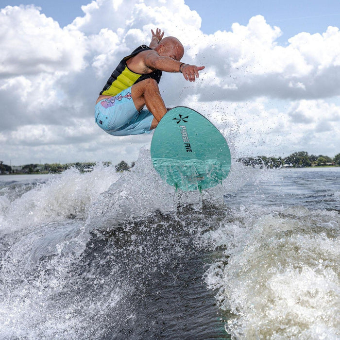 Wakesurfer catching big air with a clean ollie off the wake on the 2026 Phase 5 Trident.