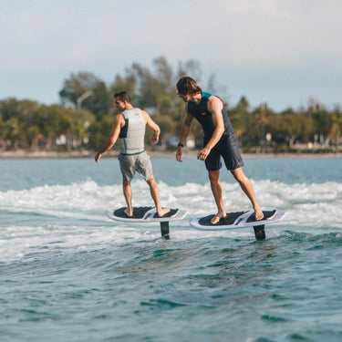 Two advanced wakefoilers executing high-efficiency pump cycles together on the second wave using Ronix advanced 29" Speed series foil setups.
