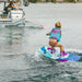 Young girl standing up for the first time on the 2026 Ronix August, showing its easy-to-ride asymmetrical design.