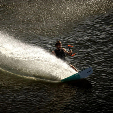Pro wakeskate rider tracking hard and carving smoothly outside the wake on the Ronix Electric Collective Wakeskate.