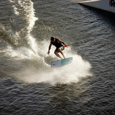 Pro wakeskater executing a clean, technical shuv-it trick on the 43 inch Ronix Electric Collective wakeskate.