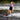 Young girl grom riding with one hand off the handle and cruising comfortably outside the wake on the 2026 Ronix Krush 125cm wakeboard setup.