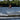 Young grom wakeboarder confidently executing a clean wake-to-wake jump and grab on the complete 2026 Ronix Kid's District 129cm wakeboard package.