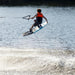Young rider performing a wake-to-wake tail grab on the 2026 Ronix Kid's Vault 130cm.