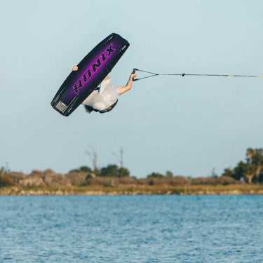 Tyler Higham launching a massive indy grab backroll using the complete 2026 One Blackout wakeboard and One wakeboard boots package.