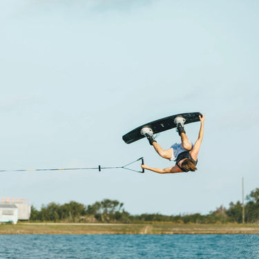 Pro rider Tyler Higham executing a massive tail grab backroll on his Ronix One Blackout with the Silver Reflective boots.