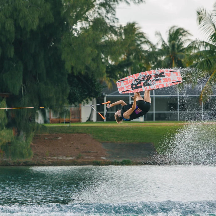 Female rider performing a massive wake-to-wake invert on the performance-driven Quarter 'til Midnight.