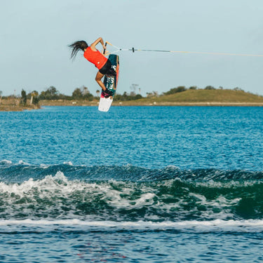 Pro rider Giulia Castelli completing a technical wake-to-wake 720 spin on her 2026 Ronix Rise wakeboard setup.