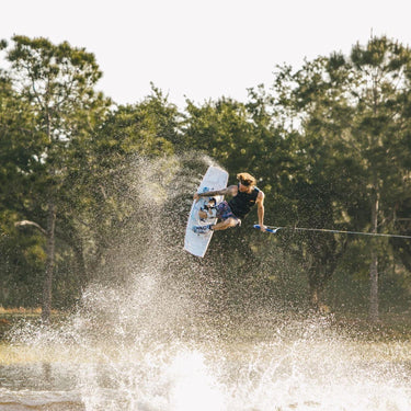 Massi Piffaretti performing a high-style stalefish grab using his pro model setup, the 2026 RXT Blackout wakeboard and RXT wakeboard boot package.
