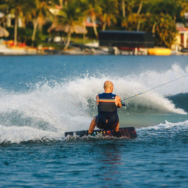 Wakeboard rider confidently carving outside the wake on the complete 2026 Ronix Vault District wakeboard setup.