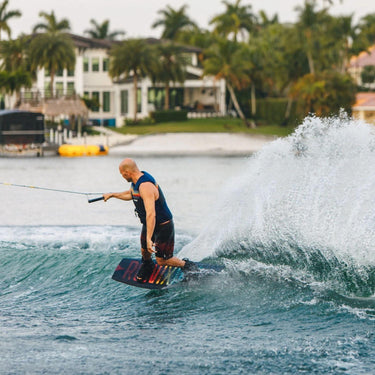 Rider confidently carving outside the wake on the complete 2026 Ronix Vault wakeboard package setup.