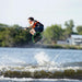 Youth rider catching air and performing a tail grab wake-to-wake jump on the 2026 Ronix Vision.