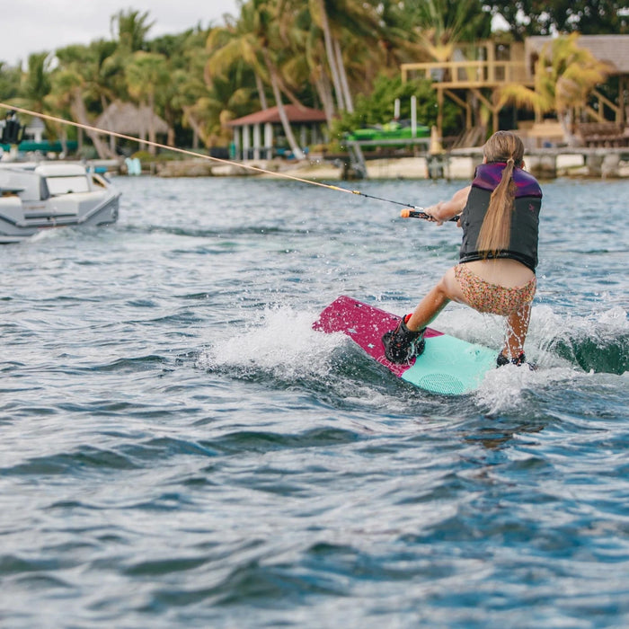 Female rider learning a deep water start on the stable and forgiving Ronix Women's Krush.