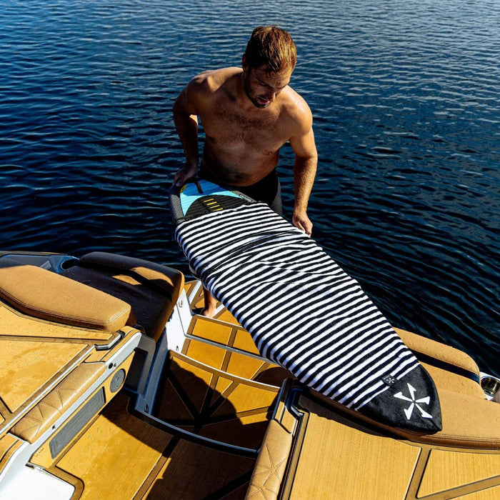 Close-up lifestyle shot of a wakesurf board inside the Black and White Phase 5 Surf Sock.