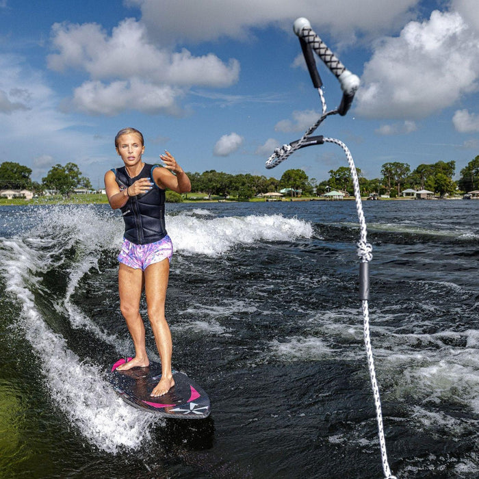 Front view of a female wakesurfer tossing the Phase 5 Standard Wakesurf Tow Rope while riding.