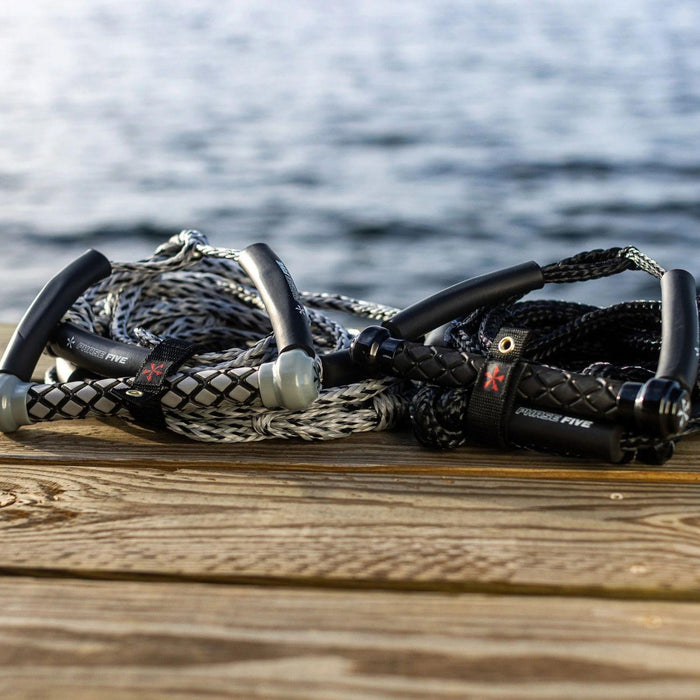 Grey and Black Phase 5 Standard Wakesurf Ropes side-by-side on a boat dock at Wakesports.