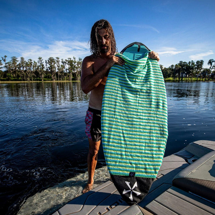 Wakesurf board inside the Lime and Blue Phase 5 Surf Sock showing the secure drawstring fit.