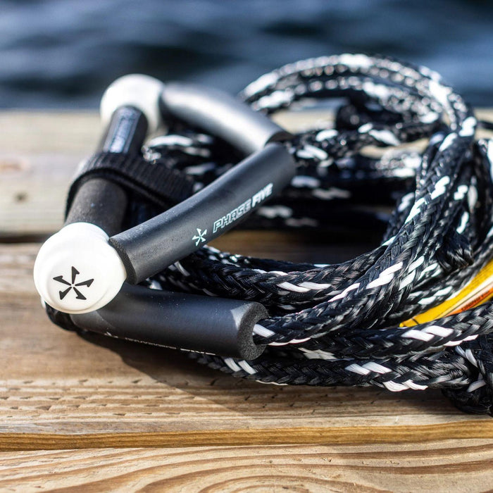 White Phase 5 Pro Surf Tow Rope coiled on boat dock - Wakesports Wakesurf Essentials.