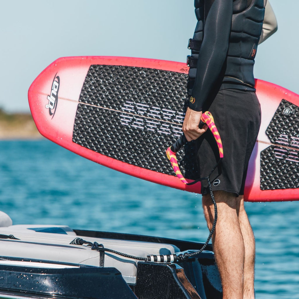 2026 Ronix DNA Flyweight Pro video showing Fishhook Tail, Button Fins, and pro riders performing airs and slashes.